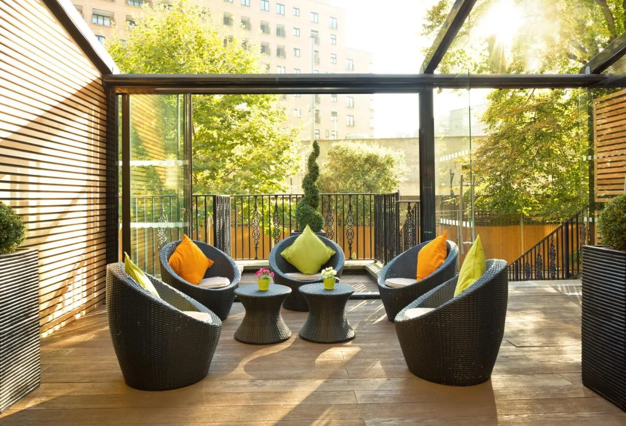 a group of chairs sitting on a patio at The Park City Grand Plaza Kensington Hotel in London